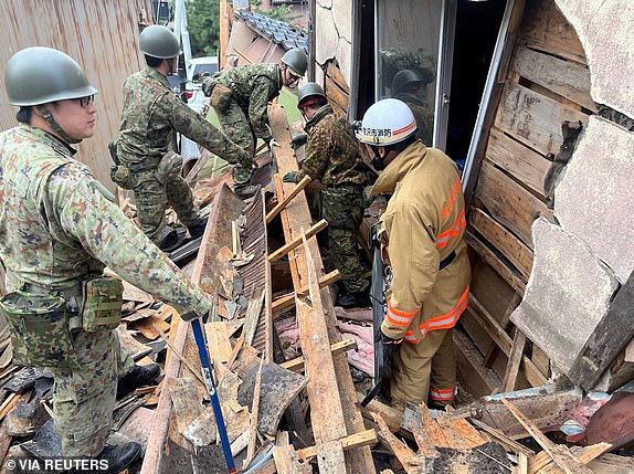 Japanese Self-Defense Force soldiers and firefighters conduct rescue operations at a collapsed house caused by an earthquake in Wajima, Ishikawa prefecture, Japan January 2, 2024, in this handout photo released by the Joint Staff Office of the Defense Ministry of Japan. Joint Staff Office of the Defense Ministry of Japan/HANDOUT via REUTERS ATTENTION EDITORS - THIS IMAGE WAS PROVIDED BY A THIRD PARTY.  MANDATORY CREDIT.
