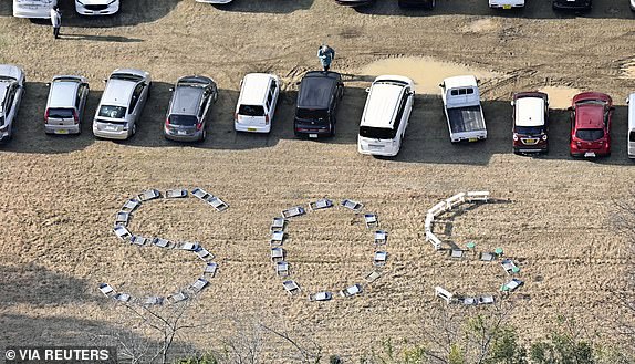 The letters "SOS" are seen written on the ground by using chairs at Kanazawa University Noto Satoyama Satoumi Meister training field after an earthquake hit the region in Suzu, Ishikawa prefecture, Japan January 2, 2024, in this photo released by Kyodo. Mandatory credit Kyodo/via REUTERS   ATTENTION EDITORS - THIS IMAGE HAS BEEN SUPPLIED BY A THIRD PARTY. MANDATORY CREDIT. JAPAN OUT. NO COMMERCIAL OR EDITORIAL SALES IN JAPAN.