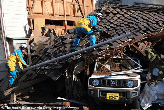 WAJIMA, JAPAN - JANUARY 02: Police officers search for survivors at a collapsed house after multiple strong earthquakes the previous day on January 2, 2024 in Wajima, Ishikawa, Japan. A tsunami warning was issued Japan's coastline after a series of earthquakes, the biggest measuring 7.6 magnitude, hit the areas around Toyama and Niigata in central Japan. At least 30 people confirmed dead in Ishikawa Prefecture, where is the epicenter of the earthquakes. (Photo by The Asahi Shimbun via Getty Images)
