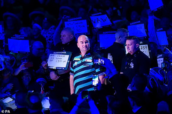 Rob Cross walks out to play Luke Littler (not pictured) on day fifteen of the Paddy Power World Darts Championship at Alexandra Palace, London. Picture date: Tuesday January 2, 2024. PA Photo. See PA story DARTS World. Photo credit should read: Zac Goodwin/PA Wire.RESTRICTIONS: Use subject to restrictions. Editorial use only, no commercial use without prior consent from rights holder.