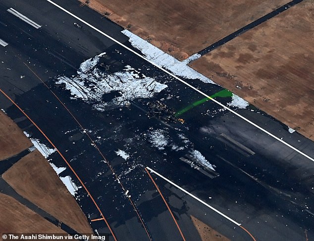 An aerial view shows the burnt Japan Coast Guard aircraft after a collision with Japan Airlines' (JAL) Airbus A350 plane at Haneda International Airport in Tokyo, as seen on Wednesday