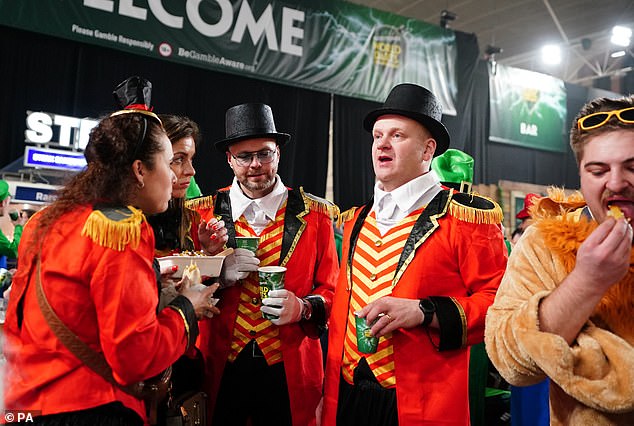 A group of fans dressed in circus master outfits before the World Darts Championship final