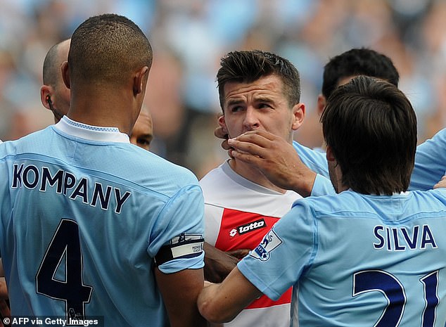 Barton  clashes with Manchester City's captain Vincent Kompany after being sent off by referee Mike Dean in 2012