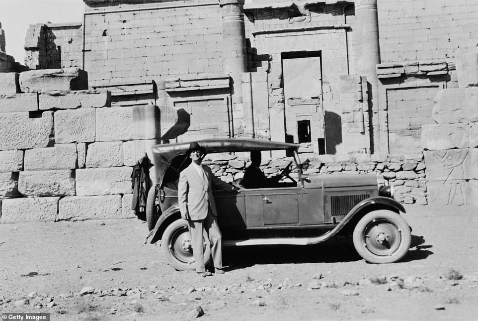A western tourist poses by his car at the temple of Pharaoh Rameses III in Karnak, Egypt, circa 1925. Nowadays, no tourist vehicles would be allowed to get so close to the ancient structures