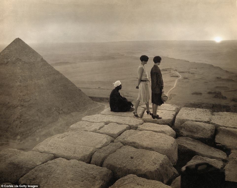 While nowadays it's forbidden for tourists to clamber up Egypt's pyramids to take a snap, back in the early 20th century it was all the rage. In this shot, two women dressed in heels and dresses look across the Sahara Desert from the top of the Great Pyramid of Khufu at sunset