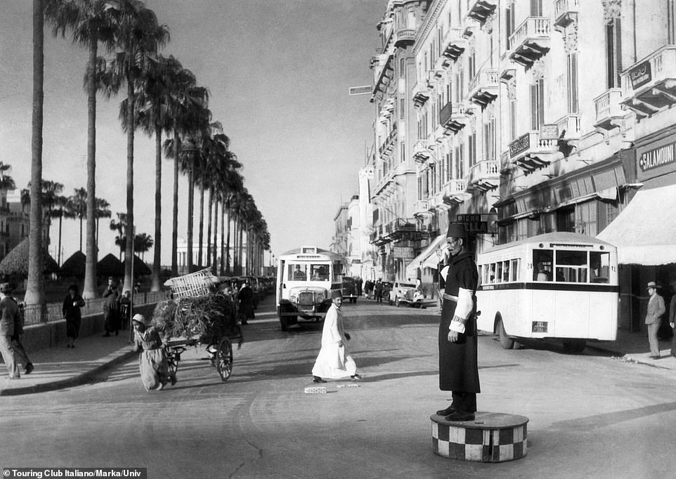 A local boy carts agricultural produce through the city Alexandria in 1930, while an attendant stands on a platform to help control the steady flow of traffic. Today the scene is a little more hectic, as Alexandria's population is more than five million compared to about 320,000 at the turn of the 20th century