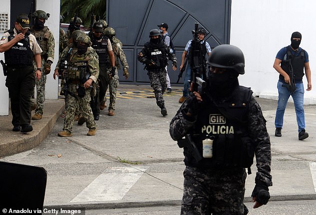 Police and soldiers take security measures as Ecuadorian police arrest several armed men who broke into the set of a public television channel on Tuesday