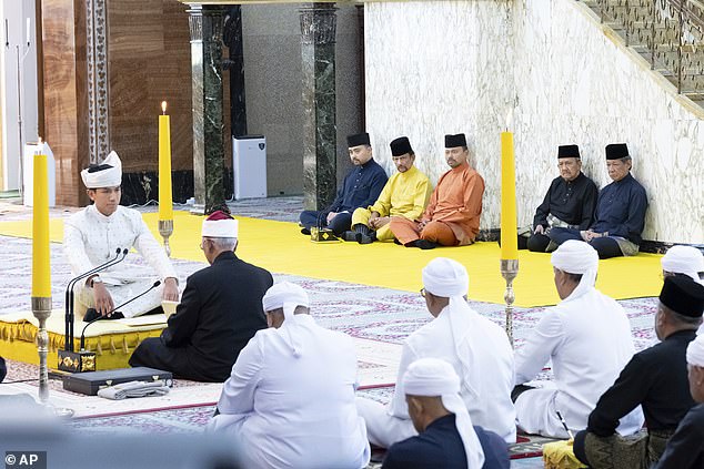 Prince Abdul, left, sitting during his solemnisation at Sultan Omar Ali Saifuddien Mosque in Bandar Seri Begawan