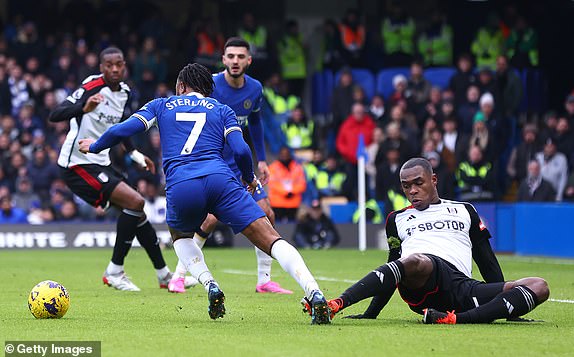LONDON, ENGLAND - JANUARY 13: Issa Diop of Fulham FC tackles Raheem Sterling of Chelsea FC resulting in a penalty during the Premier League match between Chelsea FC and Fulham FC at Stamford Bridge on January 13, 2024 in London, England. (Photo by Chloe Knott - Danehouse/Getty Images)