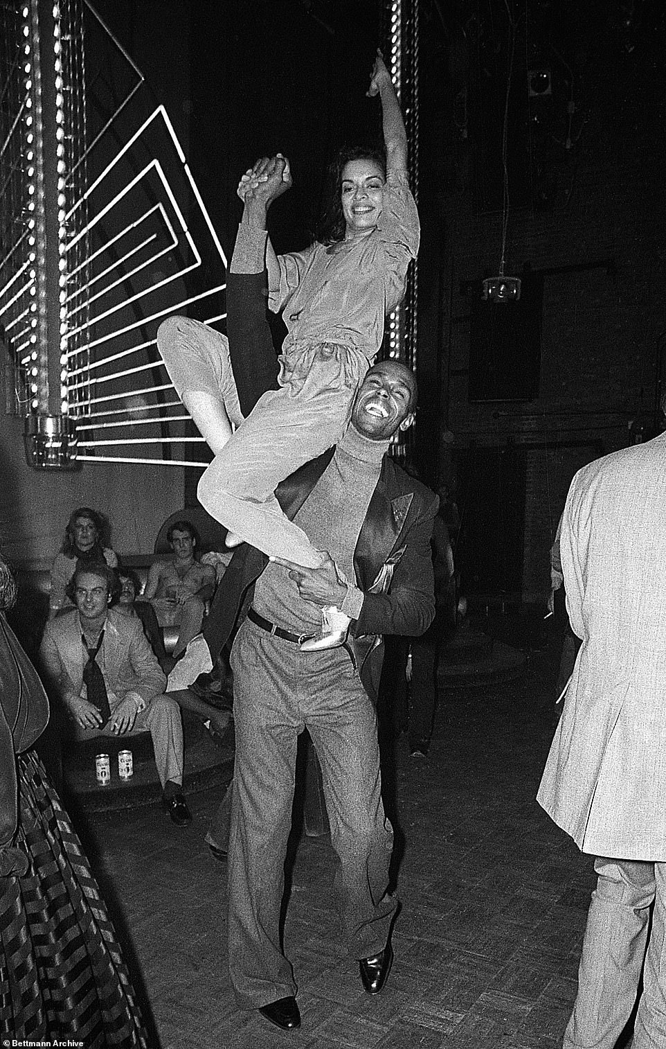 The model's charming persona, chiseled cheekbones, and dexterity charmed the likes of many including Jagger, seen here taking advantage of the 6'2'' Adonis's strength for a triumphant pose toward the end of dance number