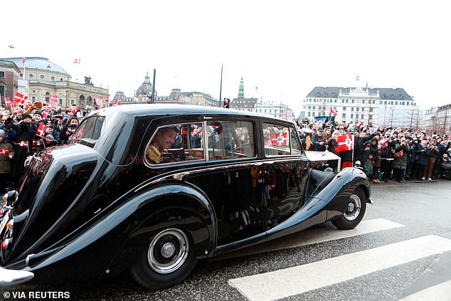 A procession of cars has set off with the royals being driven in a 1958 Rolls-Royce from Amalienborg