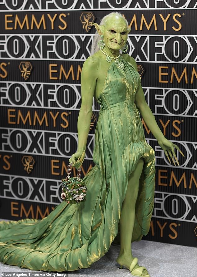 To add a bit of elegance to the outrageous ensemble, Princess Poppy donned a green shimmery strapless gown and a green and pearl necklace-earring set