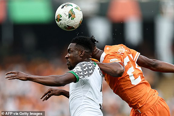 TOPSHOT - Nigeria's defender #3 Zaidu Sanusi (L) fights for the ball with Ivory Coast's forward #20 Christian Kouame during the Africa Cup of Nations (CAN) 2024 group A football match between Ivory Coast and Nigeria at the Alassane Ouattara Olympic Stadium in Ebimpe, Abidjan, on January 18, 2024. (Photo by FRANCK FIFE / AFP) (Photo by FRANCK FIFE/AFP via Getty Images)