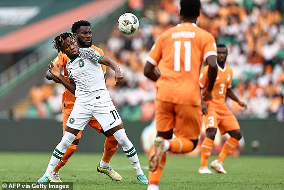Nigeria's forward #11 Samuel Chukwueze (L) fights for the ball with Ivory Coast's midfielder #8 Franck Kessie (2L) during the Africa Cup of Nations (CAN) 2024 group A football match between Ivory Coast and Nigeria at the Alassane Ouattara Olympic Stadium in Ebimpe, Abidjan, on January 18, 2024. (Photo by FRANCK FIFE / AFP) (Photo by FRANCK FIFE/AFP via Getty Images)