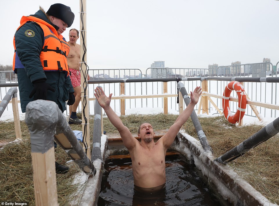 A Russian Orthodox believer bathes in the ice water of the Khimki reservoir, marking the Epiphany, on Friday in Moscow