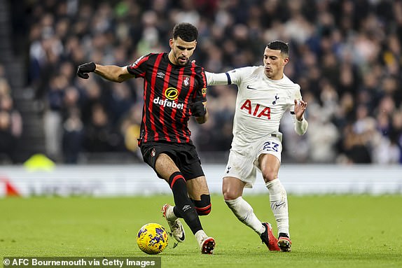 LONDON, ENGLAND - DECEMBER 31: Dominic Solanke of Bournemouth holds off Pedro Porro of Tottenham Hotspur during the Premier League match between Tottenham Hotspur and AFC Bournemouth at Tottenham Hotspur Stadium on December 31, 2023 in London, England. (Photo by Robin Jones - AFC Bournemouth/AFC Bournemouth via Getty Images)