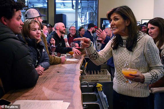 FILE PHOTO: Republican presidential candidate and former U.S. Ambassador to the United Nations Nikki Haley talks to people gathered at Deciduous Brewing, ahead of the New Hampshire primary election in Newmarket, New Hampshire, U.S., January 21, 2024.   REUTERS/Brian Snyder/File Photo