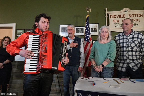 Cory Pesaturo plays the national anthem on accordion to start voting after midnight on the day of the U.S. presidential primary election in the living room of the Tillotson House at Balsams Hotel in Dixville Notch, New Hampshire, U.S., January 23, 2024. REUTERS/Faith Ninivaggi