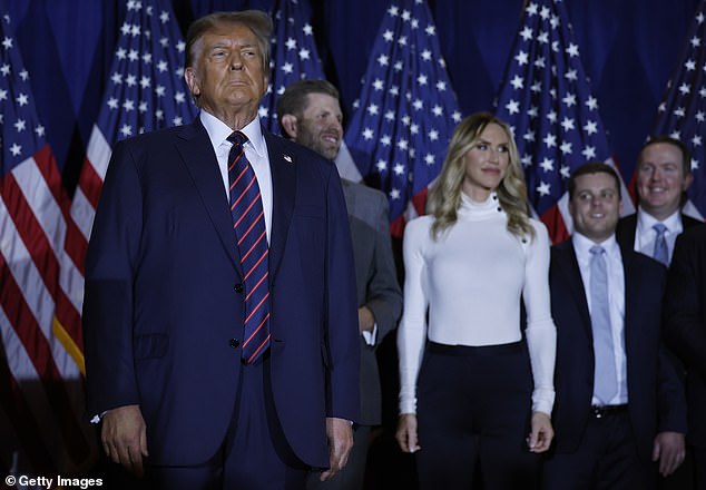 Donald Trump on stage with son Eric and daughter-in-law Lara