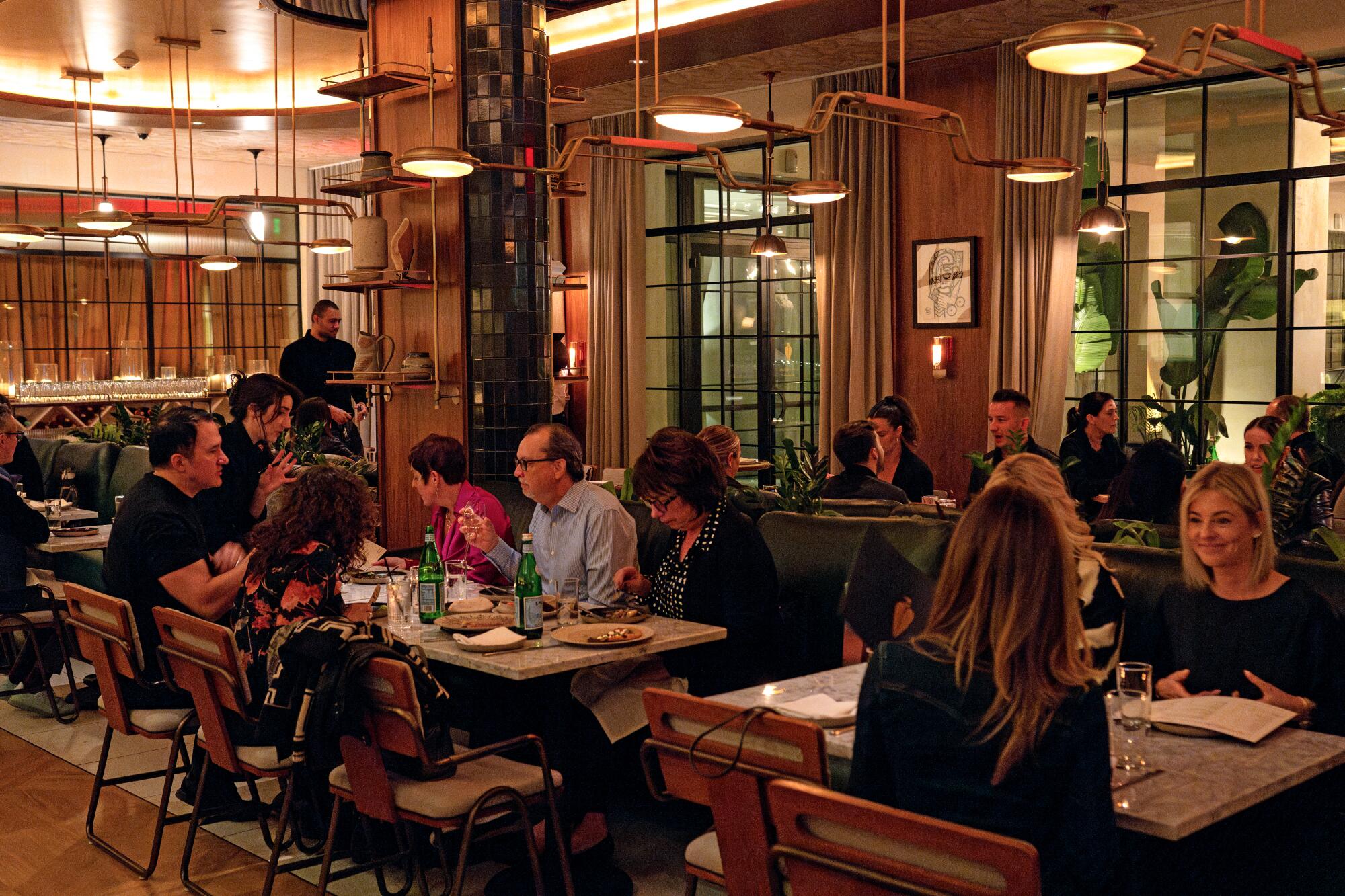 Gäste sitzen im warmen, schwach beleuchteten Speisesaal des Ladyhawk in West Hollywood. 