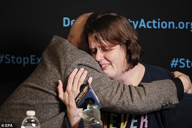 Hood (left) comforts Smith's wife Deanna at a press conference following the controversial execution