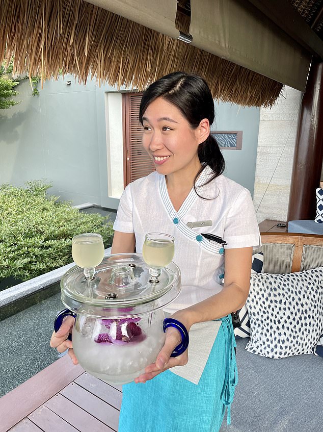 A member of staff wearing traditional Thai dress greets guests in the hotel lobby and offers them a chilled coconut and hibiscus drink which is followed later in the evening by a champagne reception