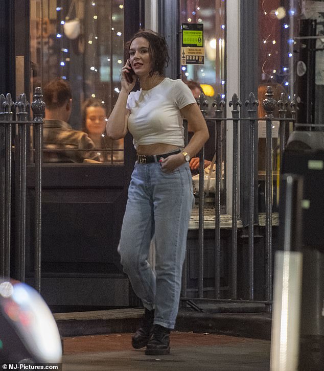 Charlotte stepped outside for a phone call as she completed her look with some faded denim jeans