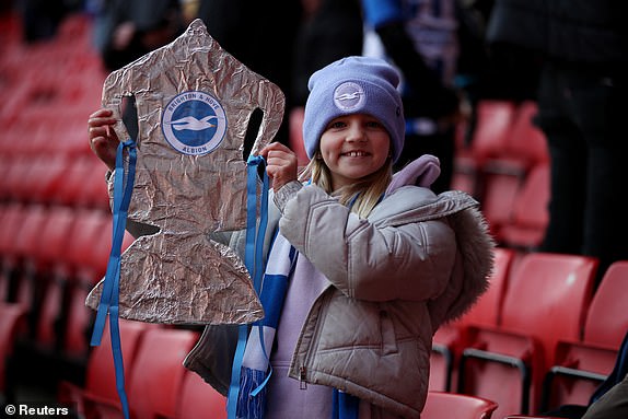 Soccer Football -  FA Cup - Fourth Round - Sheffield United v Brighton & Hove Albion - Bramall Lane, Sheffield, Britain - January 27, 2024 A Brighton & Hove Albion fan poses with a tin foil replica trophy inside the stadium before the match REUTERS/Chris Radburn