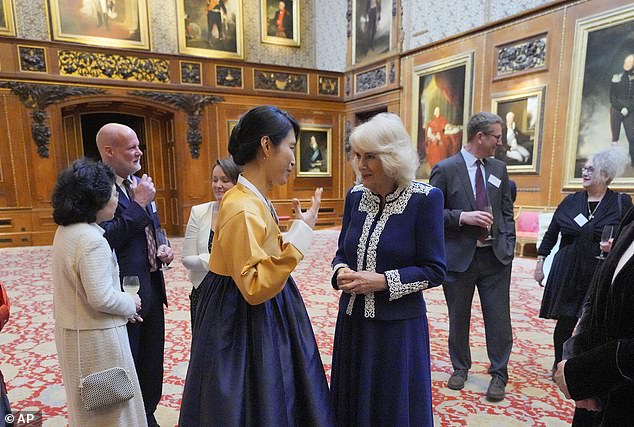 Camilla was all smiles as she chatted with the artists involved in the miniature library project today