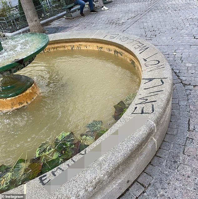 On the square's central water fountain, further graffiti penned against the show calls the Chicago-born protagonist a 's**t'