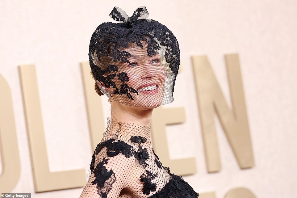 The actress wore a mesh veil which matched her dress