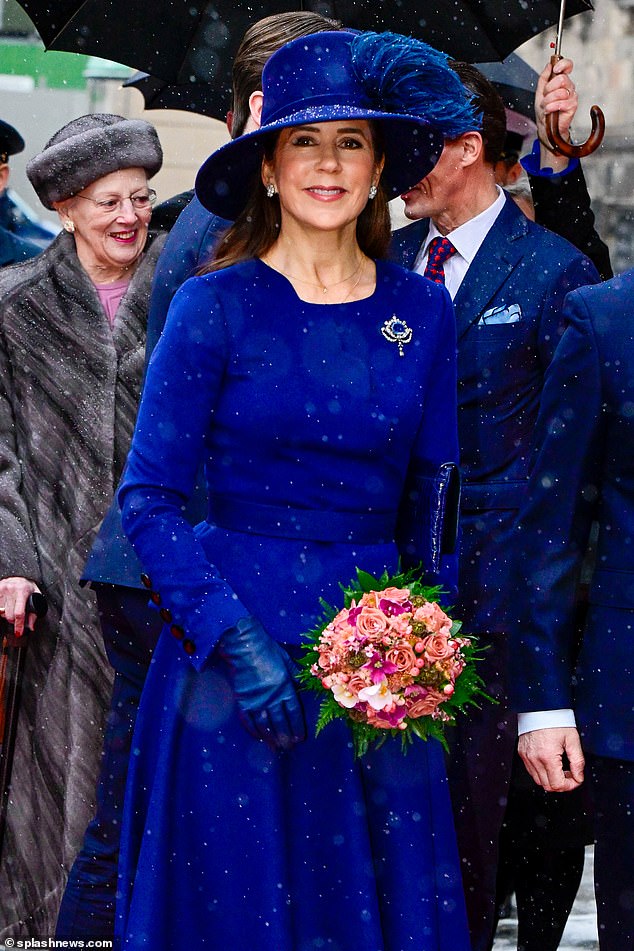 Queen Mary , 51, in a blue skirt suit and dress hat tiptoed up the stairs into Christiansborg Palace - the Danish parliament - in stilettos