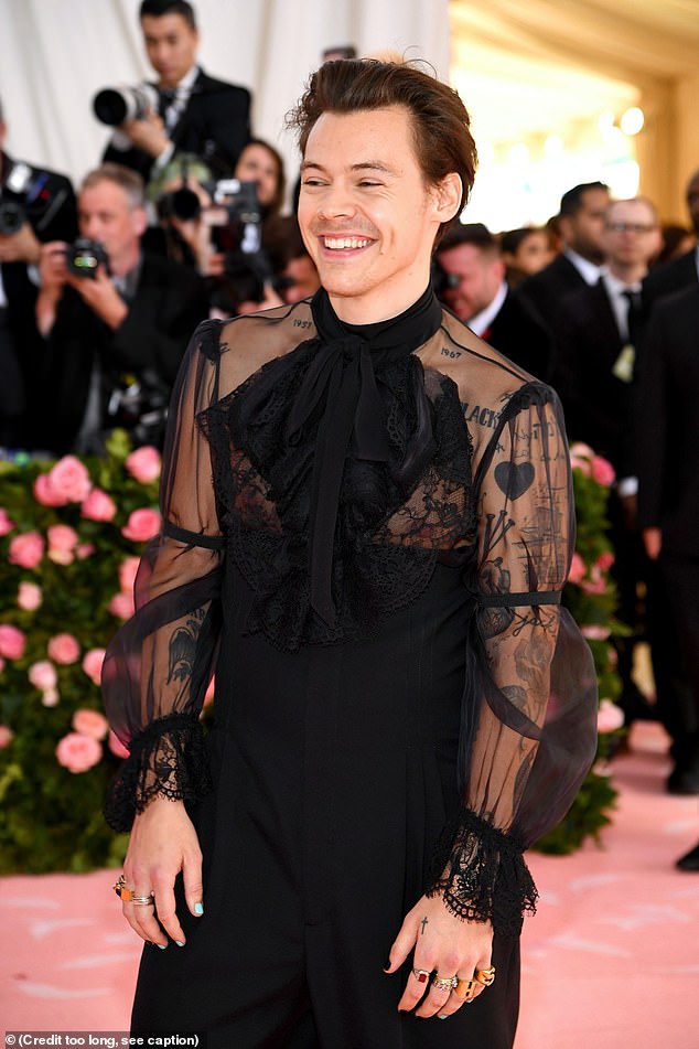 In 2019, Harry attended the Met Gala in a sheer black pussybow blouse, complete with tailored trousers and one pearl drop earring (pictured)