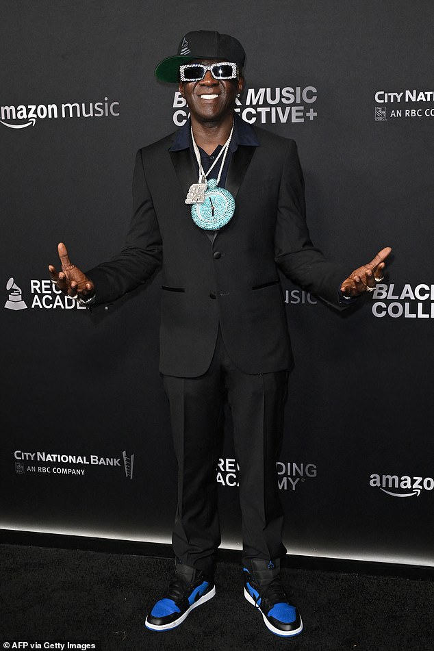 Rapper Flava Flav, 64, was cool as ever in a black suit paired with one of his signature clock chains