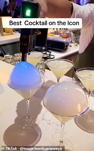 In the clip, the bartender can be seen using a contraption to form a bubble shape on top of a martini glass