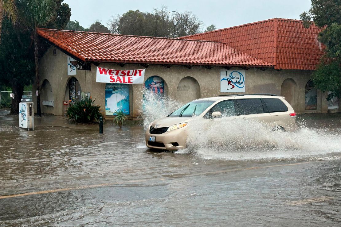 Ein Fahrzeug fährt durch Wasser auf einer überfluteten Straße in Ventura, Kalifornien.