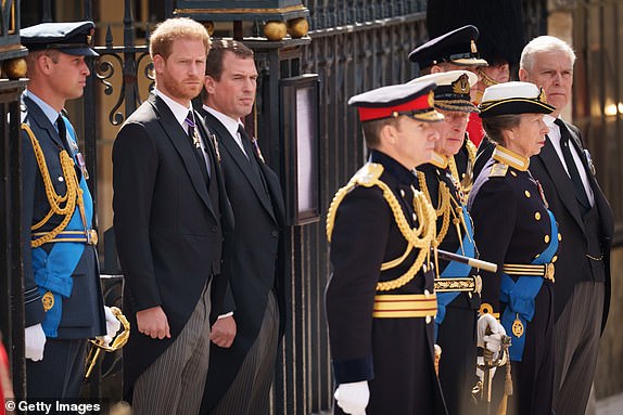 LONDON, ENGLAND - SEPTEMBER 19: Prince William, Prince of Wales, Prince Harry, Duke of Sussex, Peter Phillips, King Charles III, Anne, Princess Royal and Prince Andrew, Duke of York watch on as The Queen's funeral cortege borne on the State Gun Carriage of the Royal Navy as it departs Westminster Abbey on September 19, 2022 in London, England. Elizabeth Alexandra Mary Windsor was born in Bruton Street, Mayfair, London on 21 April 1926. She married Prince Philip in 1947 and ascended the throne of the United Kingdom and Commonwealth on 6 February 1952 after the death of her Father, King George VI. Queen Elizabeth II died at Balmoral Castle in Scotland on September 8, 2022, and is succeeded by her eldest son, King Charles III. (Photo by Christopher Furlong/Getty Images)