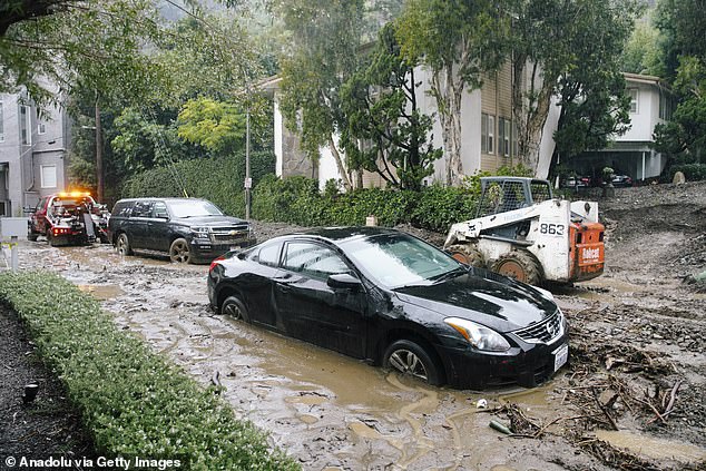 Cars are stuck in mud in Los Angeles on Monday after severe storms hit California
