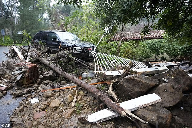 Mud, rocks and debris from a storm are strewn outside of a property Monday in Studio City
