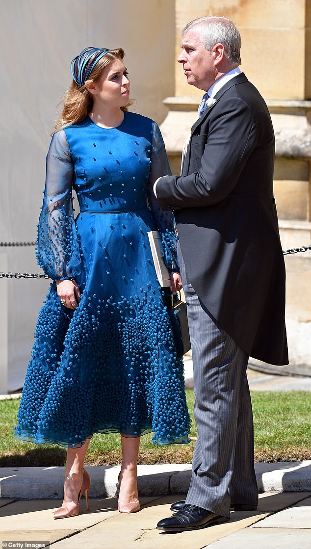 Princess Beatrice and Prince Andrew seem in good spirits at the wedding of Prince Harry to Meghan Markle at St George's Chapel in 2018