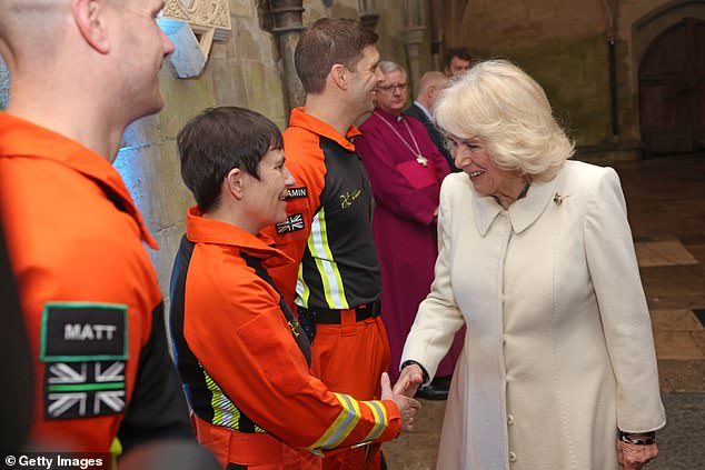 The Queen was greeted by air ambulance charity representatives as they shook hands