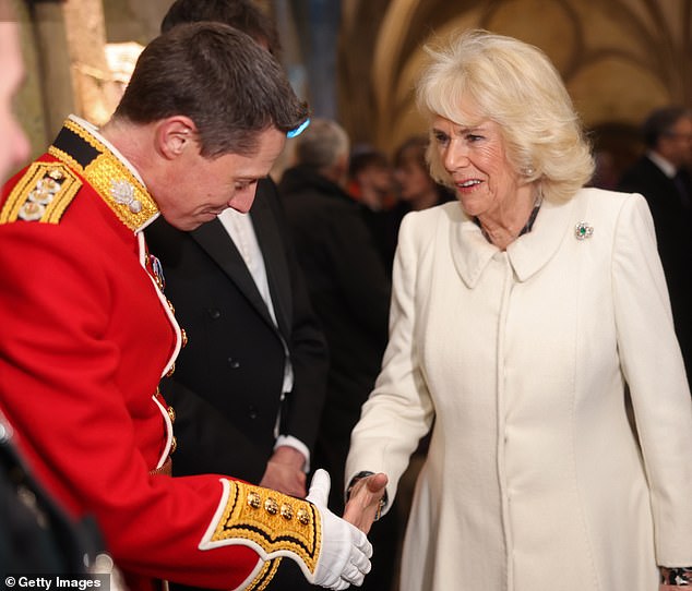 Camilla shook hands with a representative of the regimental charities of The Grenadier Guards and The Rifles