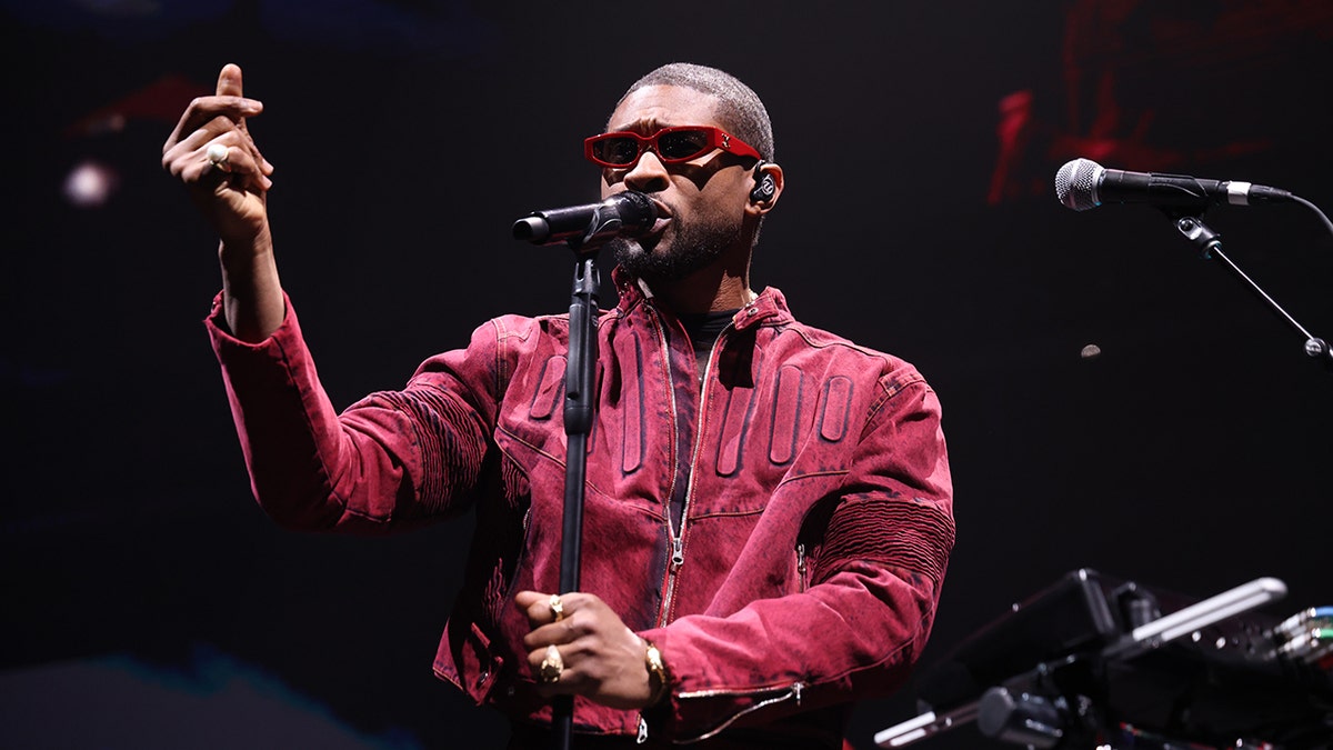 Usher tritt mit Sonnenbrille auf der Bühne auf
