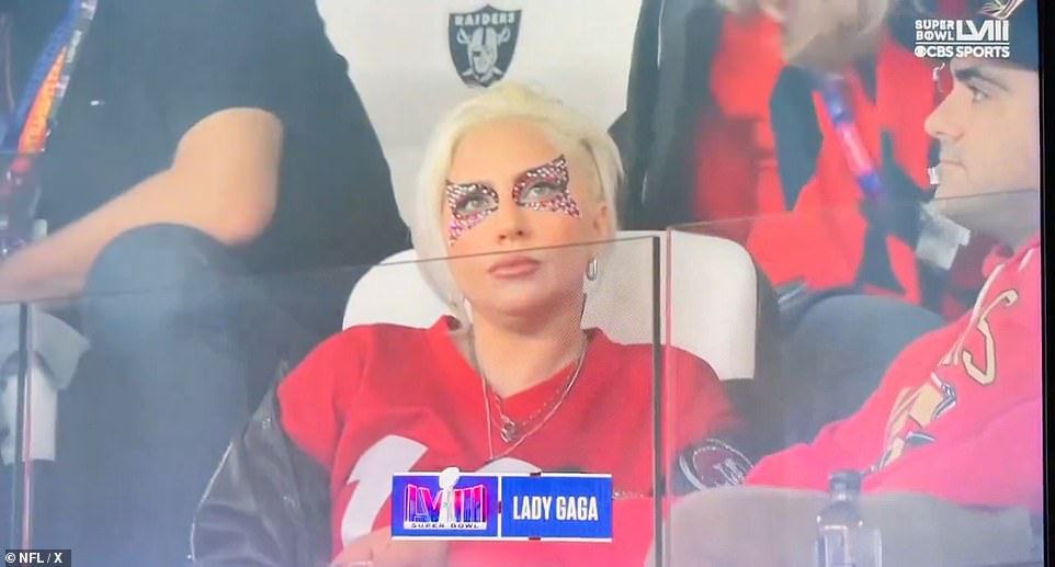 Lady Gaga, 37, put on a colorful display in bedazzled pink makeup around her eyes as she rooted for San Francisco wearing a Niners jacket