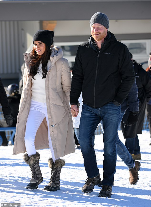 The happy pair smiled as they walked through the snow in Canada yesterday while holding hands