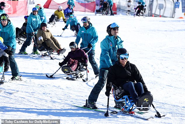 Harry was all smiles as he was assisted in his sit-skiing at the snow-sports event in Canada yesterday