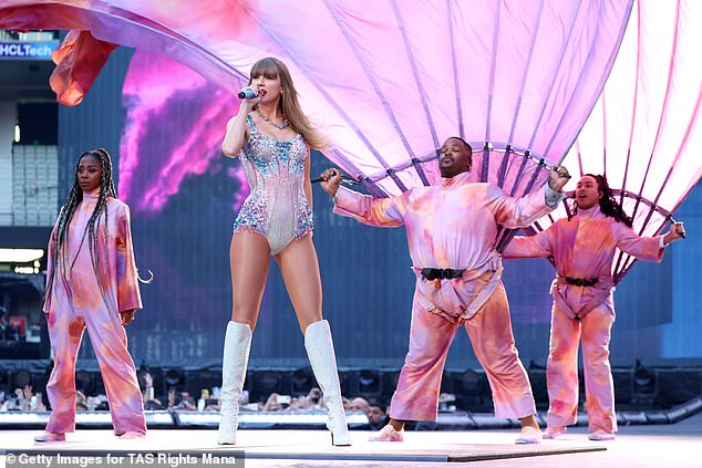 For the record-breaking night, Taylor put on a very leggy display in her signature jewelled silver and pink leotard, which she styled with matching knee-high boots