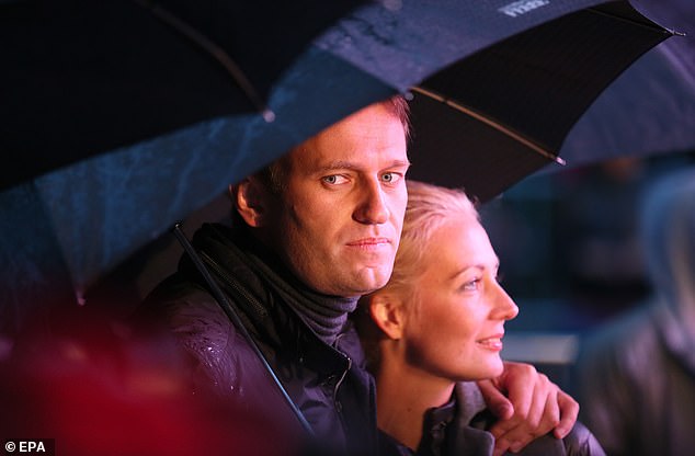 Navalny and his wife Yulia attend his last election campaign event during heavy rain in Moscow, Russia on 6 September 2013