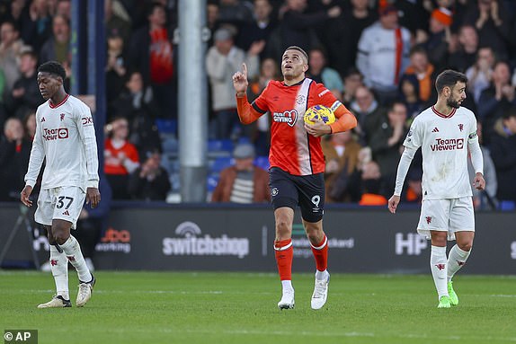 Luton Town's Carlton Morris, center, celebrates after scoring his side's opening goal during the English Premier League soccer match between Luton Town and Manchester United at Kenilworth Road, in Luton, England, Sunday, Feb. 18, 2024. (AP Photo/Ian Walton)