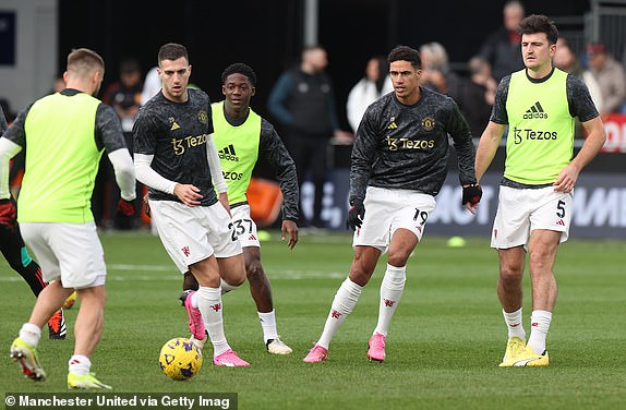 LUTON, ENGLAND - FEBRUARY 18: Diogo Dalot, Kobbie Mainoo, Raphael Varane, Harry Maguire of Manchester United warms up ahead of the Premier League match between Luton Town and Manchester United at Kenilworth Road on February 18, 2024 in Luton, England. (Photo by Matthew Peters/Manchester United via Getty Images)